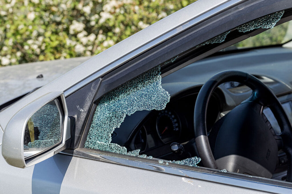 Broken driver's side window of car