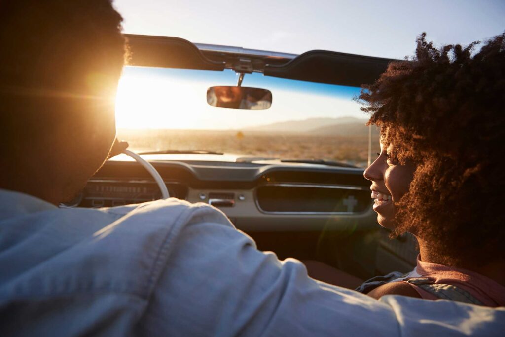 couple in a vehicle driving down a high way