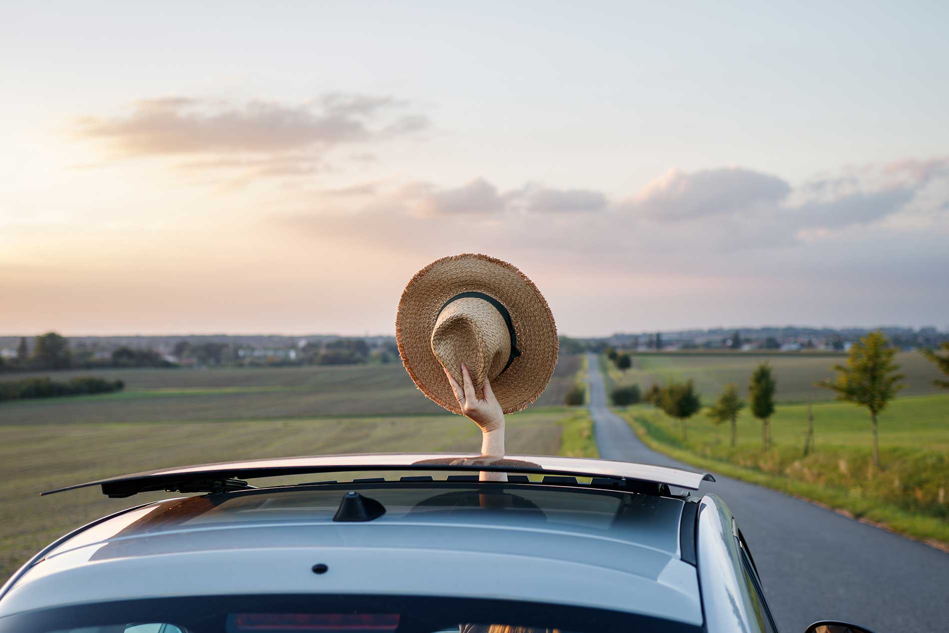 person on a road trip cheering