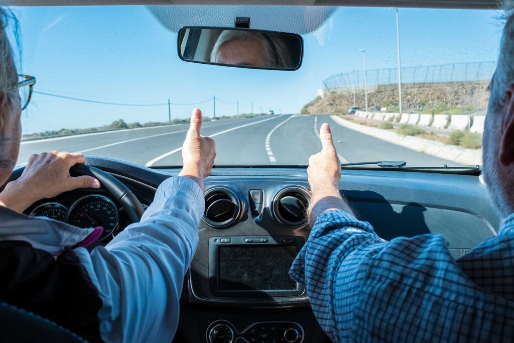 two people in a car taking a ride