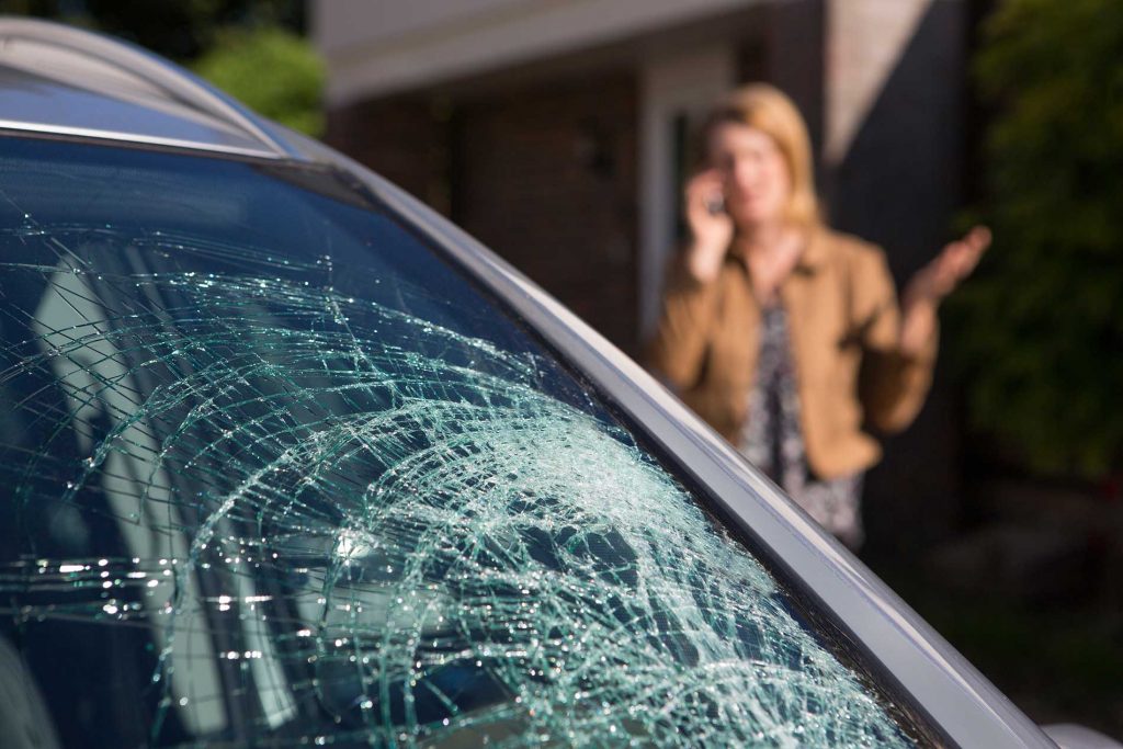 woman-with-a-broken-windshield-making-a-call